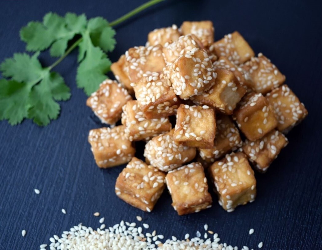 pile of fried tofu sprinkled with sesames