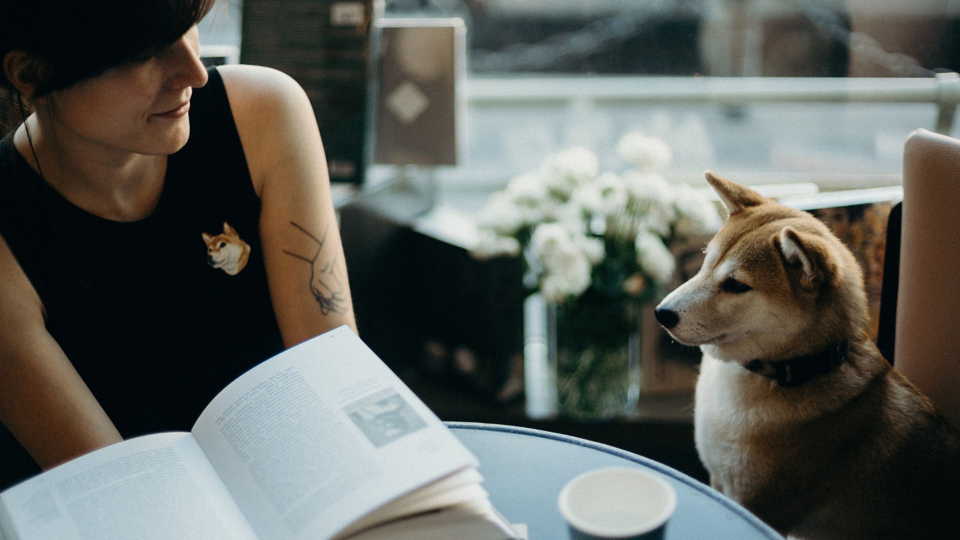 A woman journaling beside her relaxed dog—symbolizing peace, reflection, and emotional clarity.
