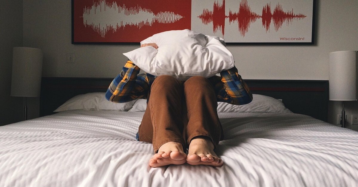 person holding pillow, representing overthinkers in need of midnight anxiety tips